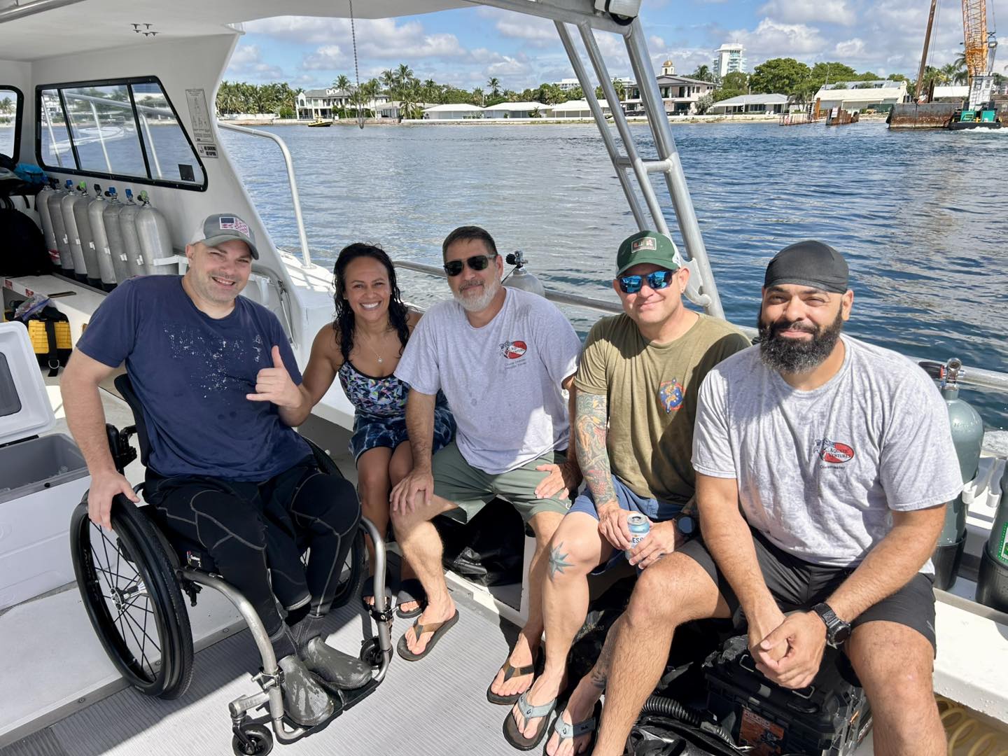Group of people on a boat with a person using a wheelchair
